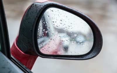 raindrops on side rearview mirror in rainy day